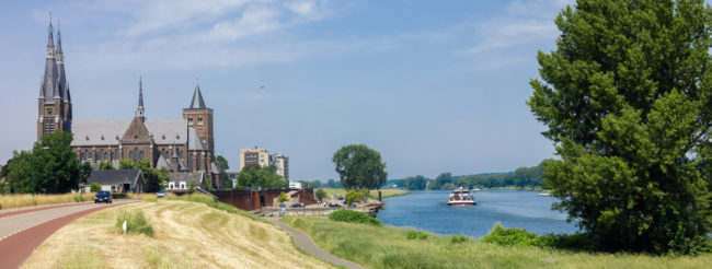 Dutch village Cuijk along river Meuse, view at Martinus church